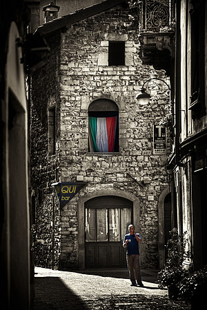 Italian Man Drinking Espresso on the Narrow Streets of Como, Italy